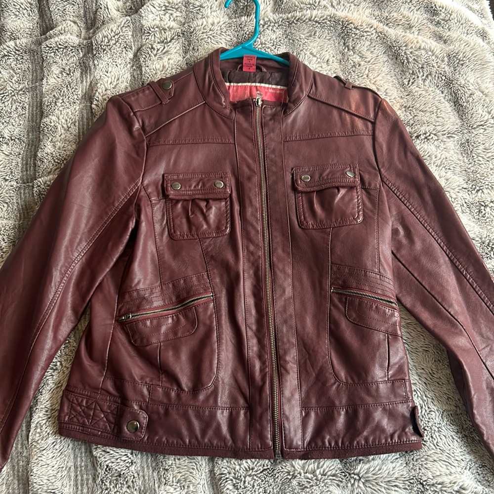 Red burgundy, leather, zip up jacket with a bunch of pockets
